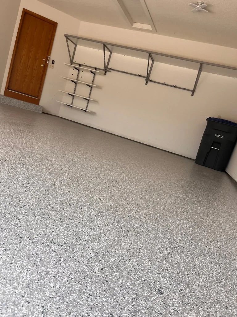 A pristine, high-gloss grey and white speckled finish following a professional Epoxy Flooring Installation