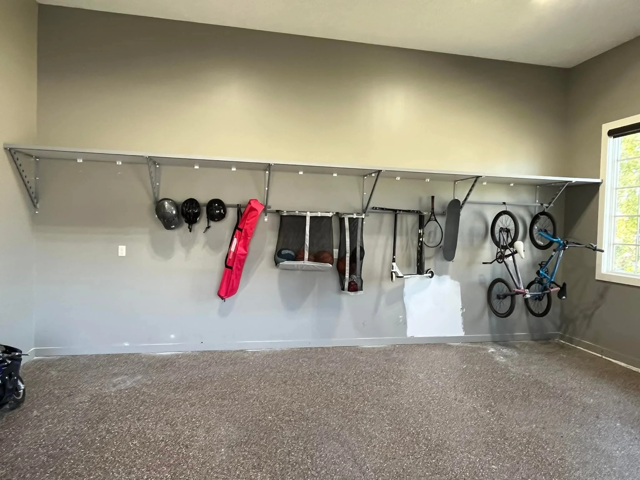 A wide-span heavy-duty shelving system mounted on finished Concrete Garage Walls