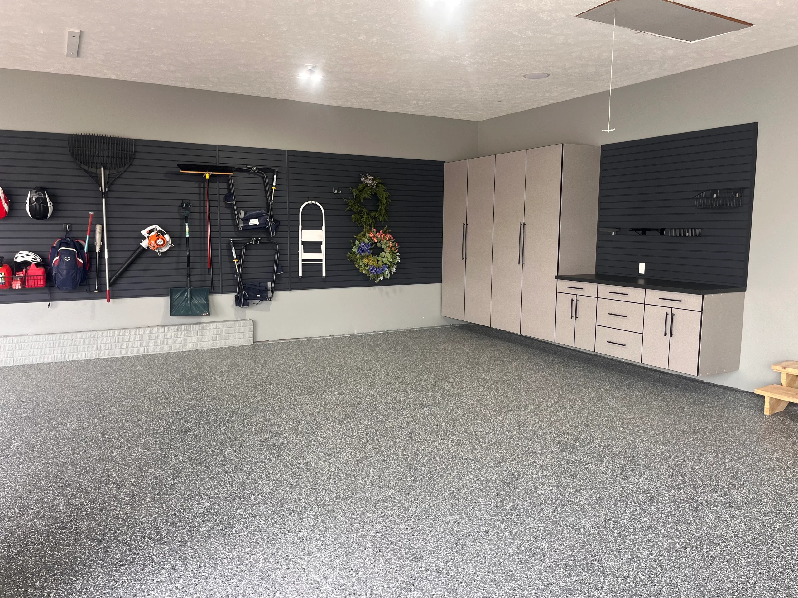 A clean and functional garage renovation featuring a Personalized Garage Workbench