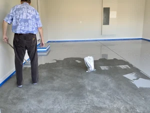 person coating garage floor